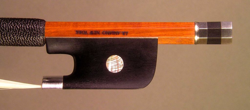 Cello Bow silver-mounted ebony frog with plain pearl eyes and divided button.