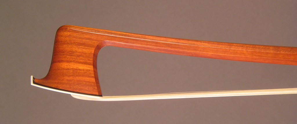 Cello Bow with an octagonal pernambuco stick, silver-mounted ebony frog with plain pearl eyes and divided button.