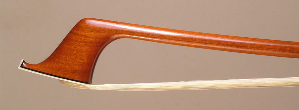 Cello Bow with a round pernambuco stick, silver-mounted ebony frog with plain eyes and divided button.
