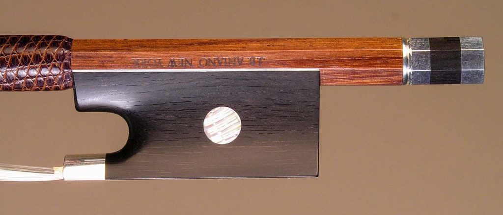 Violin Bow with a round Serebedan (Swartzia oblanceolata) stick,silver-mounted ebony frog and divided button.