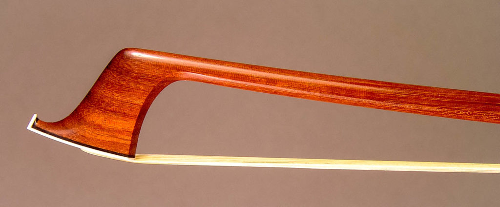 Violin Bow with a round pernambuco stick, silver-mounted ebony frog with double pearl eyes and divided button.