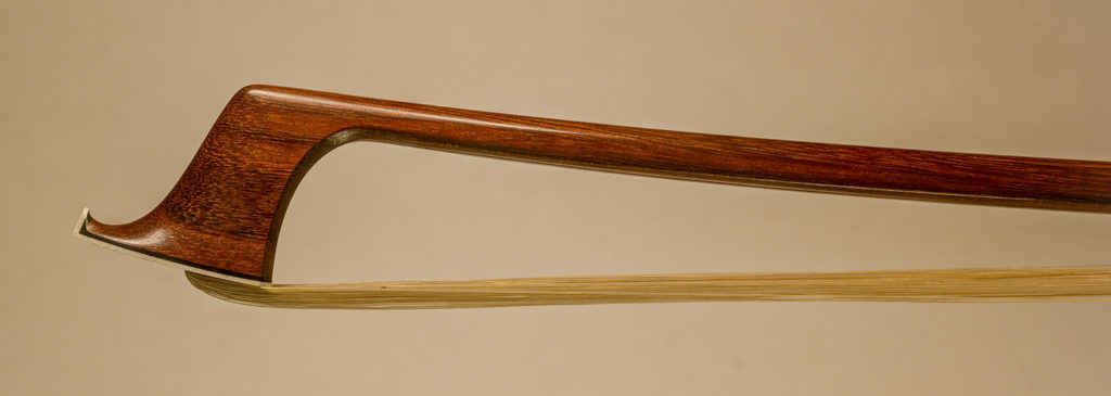 Violin Bow with a round pernambuco stick, silver-mounted light colored faux tortoiseshell frog with Parisian eyes and divided button.